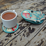 The Madhubani fish coaster set offers an opportunity to have your beverage with a history of art sitting right along with you on your dining table. These wood coasters are blessed with a captivating Madhubani Fish painting by a regional artist. The art on this coaster set is practiced in Bihar and the Mithila state of Nepal. It is done with fingers, twigs, brushes, nib-pens, and matchsticks and is characterized by attention arresting geometrical patterns. With its wide as well as flat base, it allows you to maintain cleanliness by offering ample space to your ‘about-to-spill’ tea cups, coffee mugs and spirit glasses. Along with shielding the table tops from stains, the Madhubani Fish Coaster Set is an elegant addition to home furnishing.