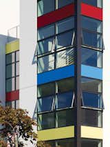 Brightly colored aluminum panels draw passersby in while corner-wrapping windows give residents a feeling of openness and sense of eyes on the community.