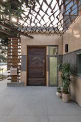 Custom copper canopy shades the exterior entry and adds a pop of color as the material oxidizes to a textured turquoise.