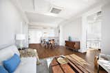 Plenty of room in this loft-like living room, dining area, and kitchen