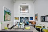 The living room is airy and expansive with a peek-a-boo cutout view of the second level