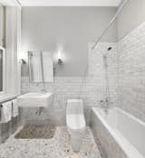 ....which is windowed and outfitted in Duravit fixtures, Carrara marble and a lovely shower/tub combo. 