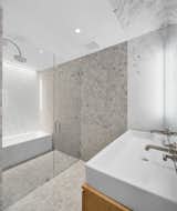 Spacious Carrara marble bathroom with rain shower and separate tub.