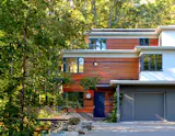 The addition follows the stepped massing of the historic house and provides the family a new mudroom entrance at the level of the driveway.