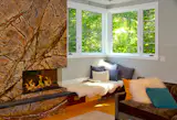 Fireplace wall is a single slab of marble with coloration and veining that allude to tree branches in winter.