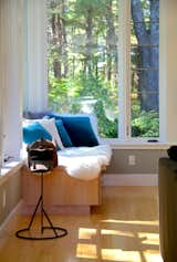 Built-in window seat with view to the wooded site.