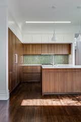 Kitchen - European fumed chestnut cabinetry, featuring quarter-sawn, sequenced veneers and an oiled finish, Miele appliances, Heath tile backsplash, Calacatta countertops, Louis Poulsen pendant lights, Recreated original baseboards, window trim, and picture rail from original 1905 detailing