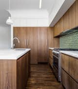 Kitchen - European fumed chestnut cabinetry, featuring quarter-sawn, sequenced veneers and an oiled finish, Miele appliances, Heath tile backsplash, Calacatta countertops, Louis Poulsen pendant lights