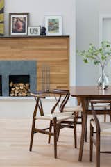 The wood used on the fireplace wall was salvaged from the floor of the old home that the architect and her husband lived in before eventually deciding to build a new home in its place. It was painstakingly salvaged, sorted, stripped, cut, and re-stained before finding new life as a wall finish.