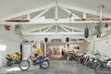 Garage – Interior walls were removed to open up the existing garage. The existing roof trusses, drywall ceiling and walls are painted white. New skylights bring ambient light into the space.
