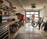 Workshop – In the workshop light floods in through a new glass garage door. The shelves are plywood on stainless steel brackets; the countertop is stainless steel. 