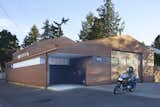 Front – Corten corrugated steel siding unifies the structure and provides a durable maintenance free finish.  Translucent polycarbonate clerestories bring light to storage and work areas