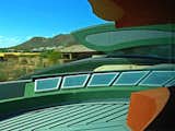 Skylights surround the concentric walls forming dining room & stairs, beautiful orange & green stucco inspired from the many desert flowers of similar hue.