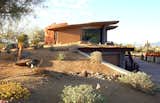 This home office and 6 car garage is completely submerged below the desert landscape, two double garage doors at each end provide vehicle access, while 2 sets of stairs service the upper office. 