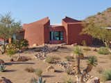 This home office and 6 car garage is completely submerged below the desert landscape, two double garage doors at each end provide vehicle access, while 2 sets of stairs service the upper office. 
