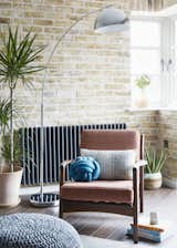 Living Room, Bamboo Floor, Chair, and Floor Lighting A vintage Danish teak armchair sits against a London stocks brick wall.  Photos from Artillery House