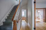 AFTER - Restored original woodwork is paired with flat grey paint on the treads & risers for an understated look.