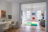 Kids, Playroom, Desk, Chair, Boy, Medium Hardwood, and Pre-Teen AFTER - Son's study area and activity room with giant wall climbing pegboard.  Kids Playroom Boy Medium Hardwood Photos from SouthEnd RowHome