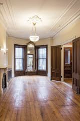 BEFORE - Traditional parlor area with original ornate plaster, doors and trim.