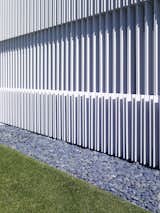 The vertical louvers provide a unique architectural contrast to the building’s strong horizontal elements.