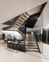 A dynamic glass and steel staircase stretching through the core of the structure serve two purposes: practically, it would provide a very straightforward answer to the vast home’s circulation; visually, it would join otherwise be disparate areas in one’s line of sight. 