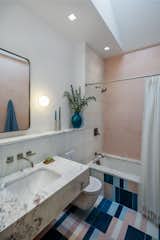 Bath Room, Concrete Wall, Undermount Tub, Cement Tile Floor, One Piece Toilet, Stone Tile Wall, Marble Counter, Undermount Sink, Wall Lighting, and Ceiling Lighting Pink and white tadelakt bathroom  Photo 15 of 25 in Nomadic Nest by Andrew Mikhael Architect