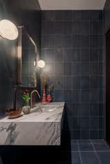 Bath Room, Wall Lighting, Cement Tile Floor, Marble Counter, Corner Shower, Concrete Wall, Recessed Lighting, Full Shower, Undermount Sink, One Piece Toilet, and Open Shower Dark concrete tile and matching tadelakt in bathroom  Photo 19 of 25 in Nomadic Nest by Andrew Mikhael Architect