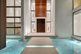 Residence front entrance with floating stepping stones and reflecting pond  Photo 1 of 8 in Allison Road Residence by Choeff Levy Fischman