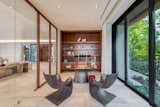The home's office is adjacent to the living room with views of lush landscape.  Photo 8 of 18 in North Bay Road Residence by Choeff Levy Fischman