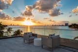 An outdoor seating area on one of the home's many balconies has great views of the sunset.