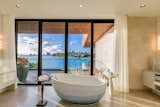 A freestanding tub sits in the center of the master bathroom suite with views of the bay.