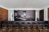 In the kitchen, matte-finish oak cabinetry, a black countertop and black backsplash provide a masculine, monochromatic feel.
