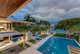 From one of the home's master suites, one can see the oversized pool, reflecting ponds, the master balcony and the water.