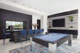 Entertainment room or "man cave" with bar and pool table.