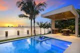 The home offers magnificent vistas of Biscayne Bay, Indian Creek Lake, and Indian Creek Country Club and a private, 500-square-foot boat dock that accentuates and amplifies the prime waterfront locale.