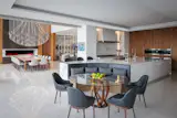 Open kitchen with a expansive island and built-in curved banquette