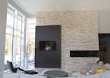 Fireplace and tv mixed with the straight lines of the stone and wood 