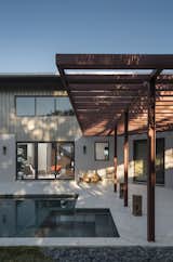 The sun-shade beside the pool plays with the horizontal and vertical repetition of the exposed beams that are not only the heart of the home's construction but also its design.