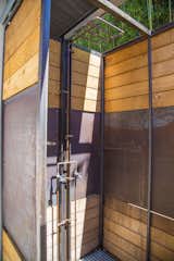 Metal work is seen throughout the exterior design, including on the outdoor shower. Young and his sons used existing copper piping to make their own shower head. "It has now oxidized and is starting too look really cool," said Young. 

