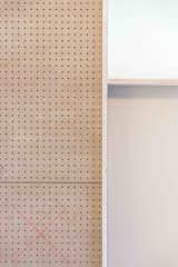 The cabinet is made out of perforated wood and laminated in light and playful colors. 