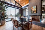 Dining Room, Table, Chair, Medium Hardwood Floor, Pendant Lighting, and Wood Burning Fireplace Dining room with a pass thru    Photo 3 of 9 in A Ralph Evans Home by Mony Ty / Summit Sotheby's 