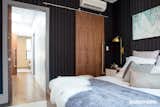 Master bedroom looking into hallway.  Custom walnut sliding barn doors open up the spaces.