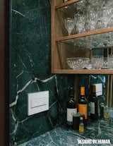 Marble countertop wraps all the way around bar.