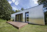 The corrugated aluminum cladding was chosen to help mimic local agricultural buildings