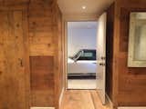 Old Barn plank flooring was reused as wall panels and interior doors.  The surface of the planks were brush sanded and installed naturally without any coating.  
