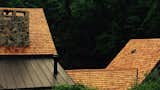 New Cedar Shake Roof against the summer forest foliage.    Photo 5 of 10 in The Fleecydale Barn by Alpha Genesis Design Build, LLC