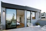 San Francisco Renovation by Designpad Architecture bedroom patio with concrete flooring and wood siding
