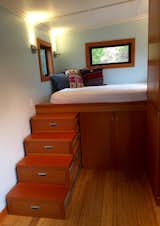 Tonsu stairs leading to queen size bed. Stairs can slide beneath bed to provide more space in living area. Additional storage beneath bed
