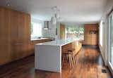 Kitchen with long island, custom rift white oak cabinets, walnut floor