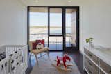 The bedrooms, including this nursery, capture beach views with floor-to-ceiling windows.